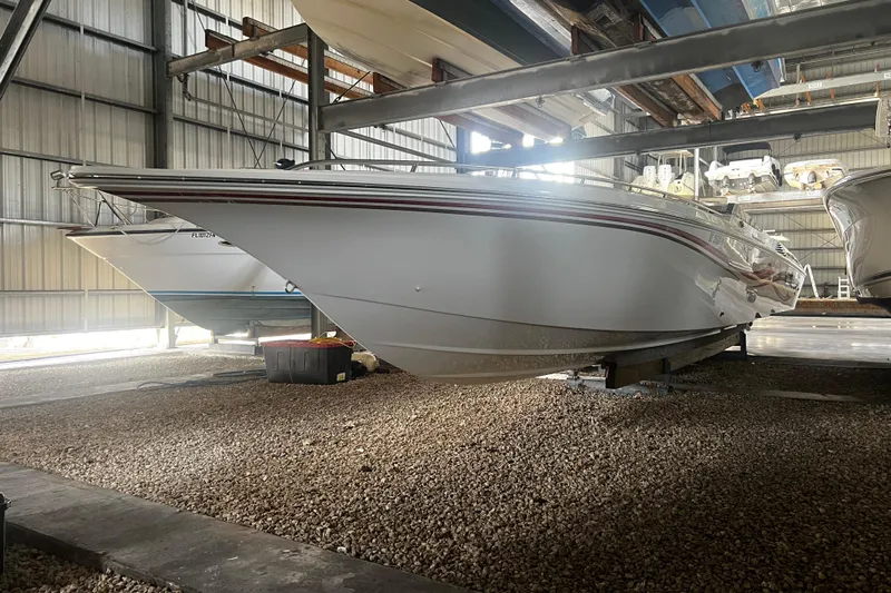  Yacht Photos Pics 2009 Fountain 42 Executioner boat in storage, side view, indoors.