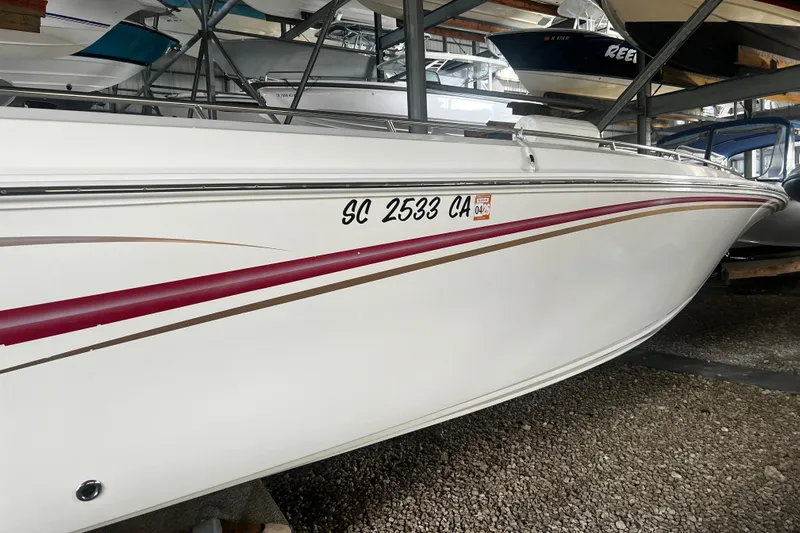  Yacht Photos Pics 2009 Fountain 42 Executioner boat in storage, white with red and gold accents.