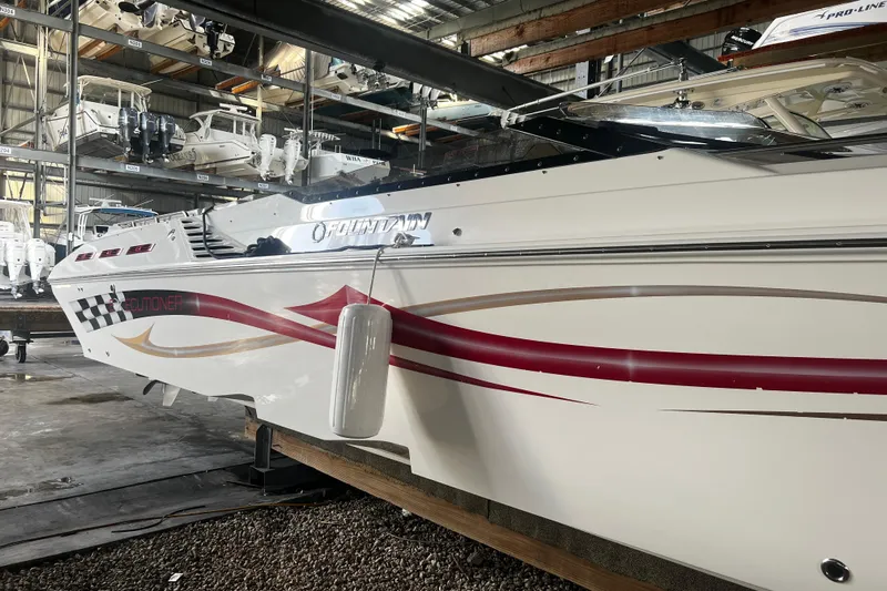  Yacht Photos Pics 2009 Fountain 42 Executioner boat in storage, featuring sleek design and vibrant graphics.
