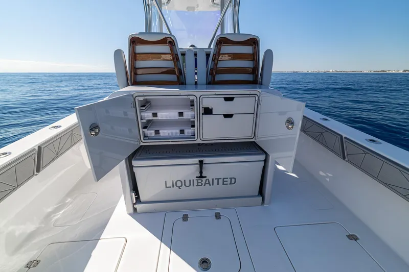  Yacht Photos Pics 2026 SeaVee 320B boat with open storage compartments on a calm ocean.