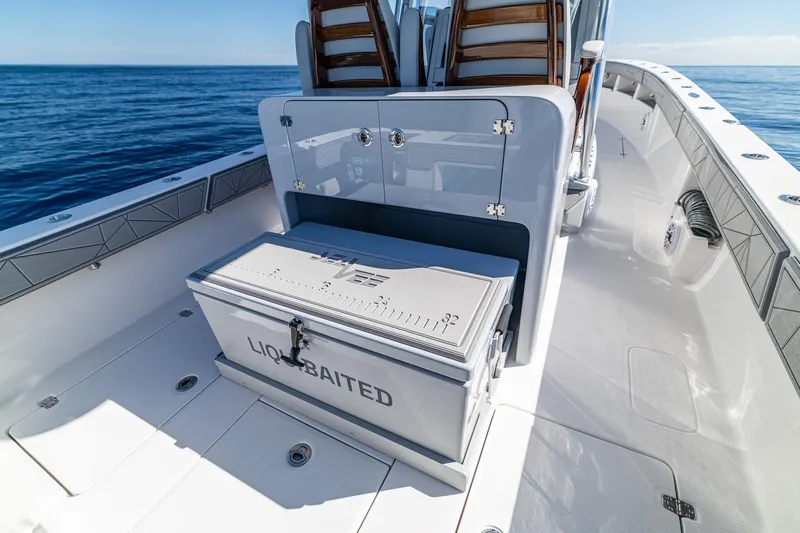  Yacht Photos Pics 2026 SeaVee 320B boat deck with storage and seating, cruising on open water.