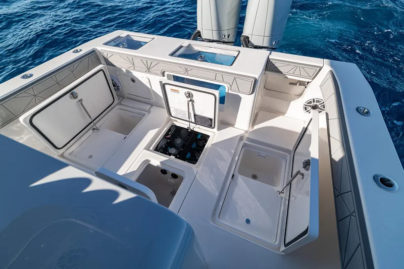  Yacht Photos Pics 2026 SeaVee 320B boat deck with open storage compartments and ocean backdrop.