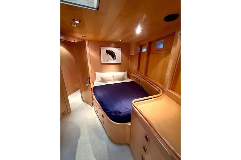 Persistence Yacht Photos Pics Luxurious 1989 Sensation yacht bedroom with wooden interior and cozy bedding.