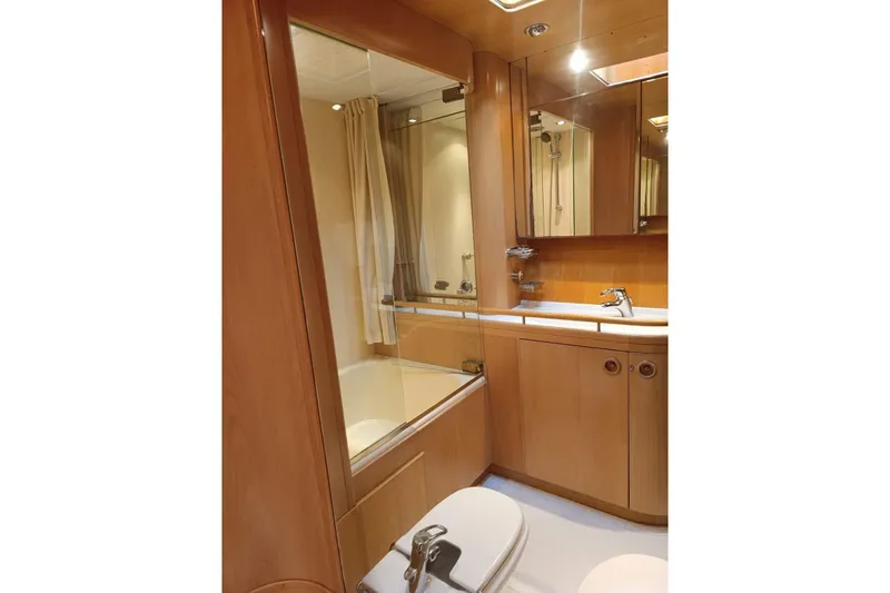 Persistence Yacht Photos Pics Luxurious 1989 Sensation yacht bathroom with wooden cabinetry and modern fixtures.