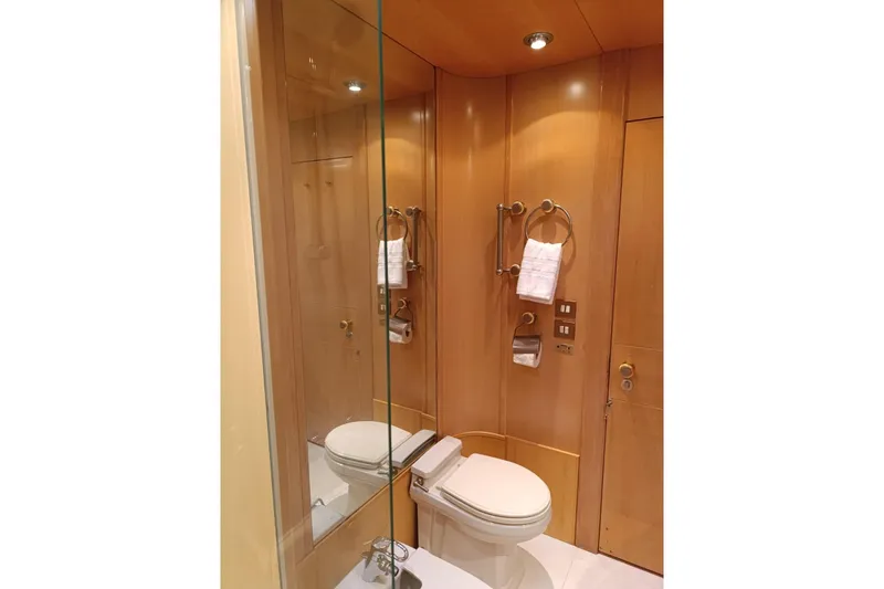 Persistence Yacht Photos Pics Luxurious 1989 Sensation yacht bathroom with wooden paneling and modern fixtures.
