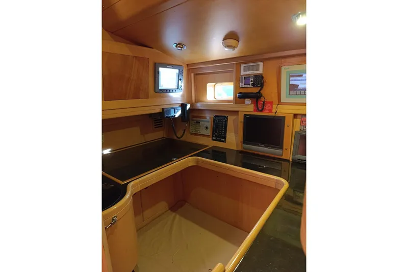 Persistence Yacht Photos Pics 1989 Sensation yacht interior with navigation equipment and wooden cabinetry.