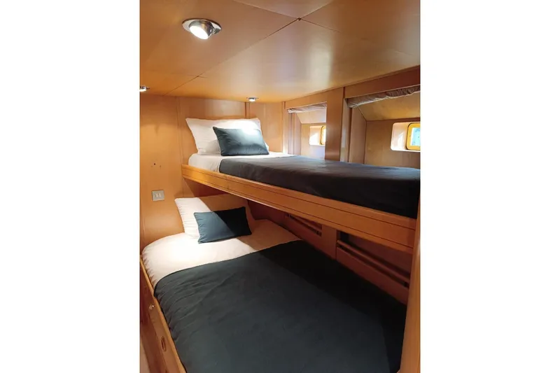 Persistence Yacht Photos Pics 1989 Sensation yacht interior with cozy wooden bunk beds and soft lighting.
