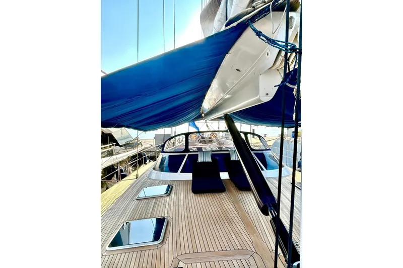 Persistence Yacht Photos Pics 1989 Sensation yacht deck with blue canopy and sleek wooden finish.