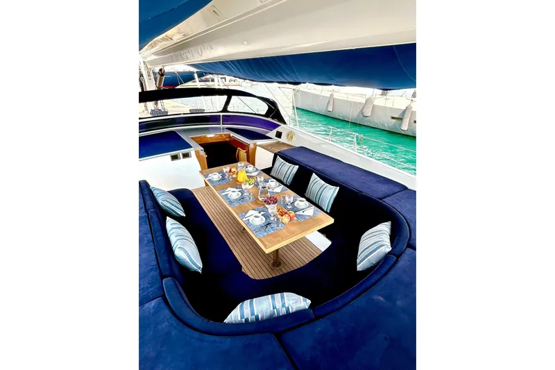 Persistence Yacht Photos Pics Luxurious 1989 Sensation yacht with elegant dining setup and plush seating.