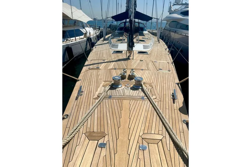 Persistence Yacht Photos Pics 1989 Sensation yacht with wooden deck, docked among other boats.