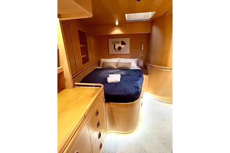 Persistence Yacht Photos Pics Luxurious 1989 Sensation yacht bedroom with elegant wood finish and cozy bedding.