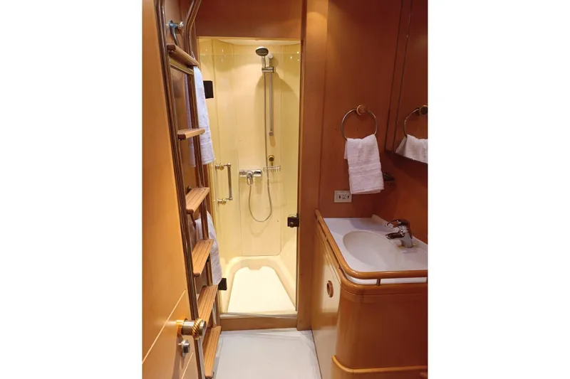 Persistence Yacht Photos Pics Luxurious 1989 Sensation yacht bathroom with shower, sink, and wooden accents.
