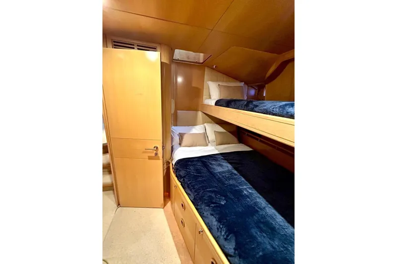Persistence Yacht Photos Pics 1989 Sensation yacht interior with cozy wooden bunk beds and plush bedding.