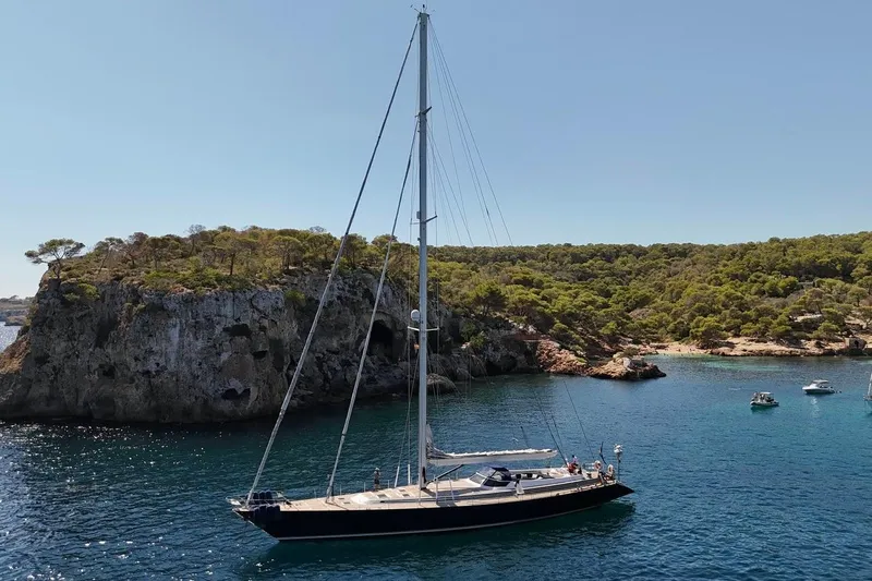 Persistence Yacht Photos Pics Sailing yacht "Sensation" from 1989 anchored near a scenic rocky coastline.