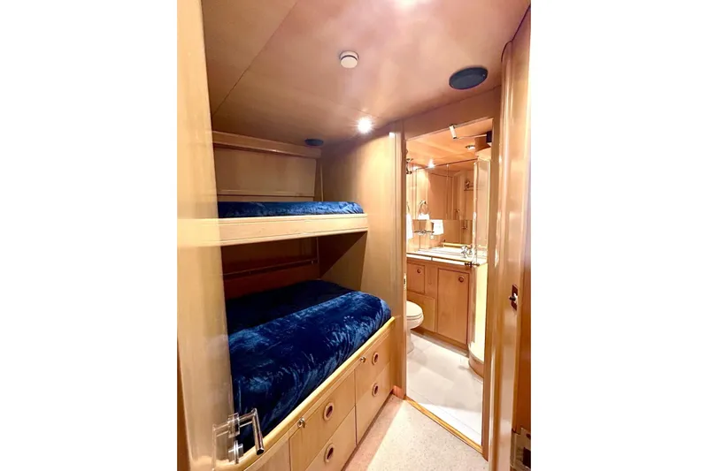Persistence Yacht Photos Pics Interior of 1989 Sensation yacht with bunk beds and bathroom, featuring wooden finishes.