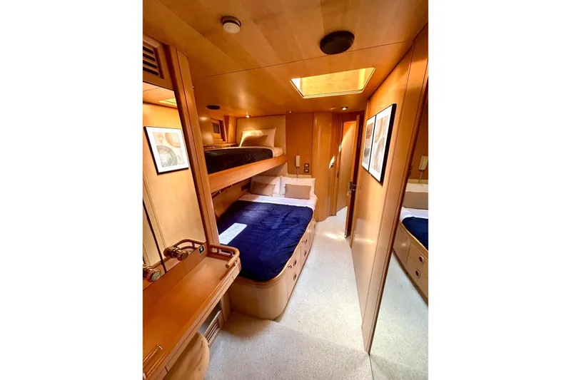 Persistence Yacht Photos Pics Luxurious 1989 Sensation yacht cabin with wooden interior and cozy bedding.