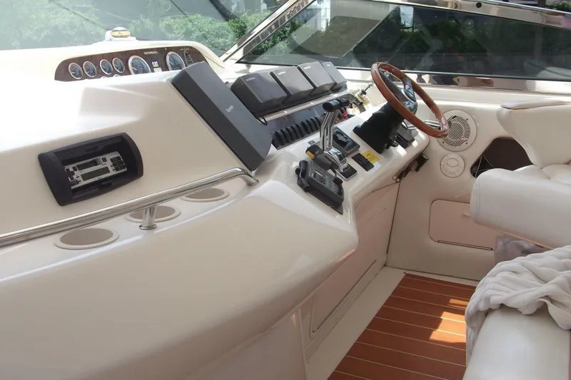  Yacht Photos Pics 1997 Sea Ray 450 Sundancer helm with steering wheel and control panel.