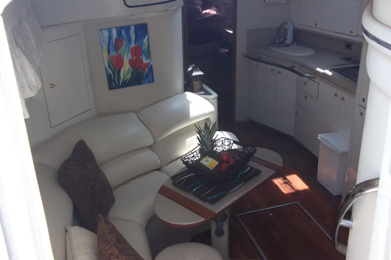  Yacht Photos Pics Interior of 1997 Sea Ray 450 Sundancer yacht with cozy seating and kitchen area.