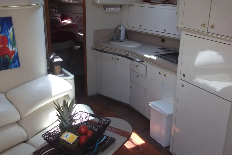  Yacht Photos Pics Luxurious 1997 Sea Ray 450 Sundancer yacht interior with modern kitchen and cozy seating area.