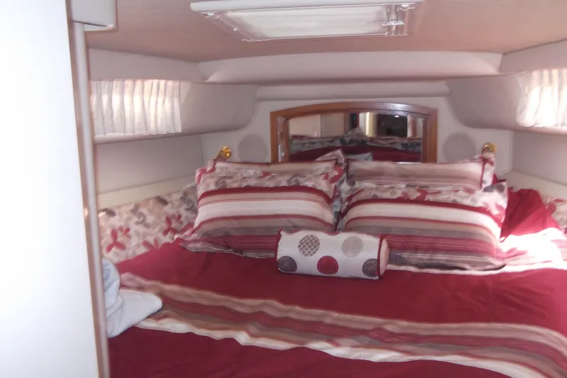  Yacht Photos Pics Cozy bedroom interior of 1997 Sea Ray 450 Sundancer yacht with striped bedding.