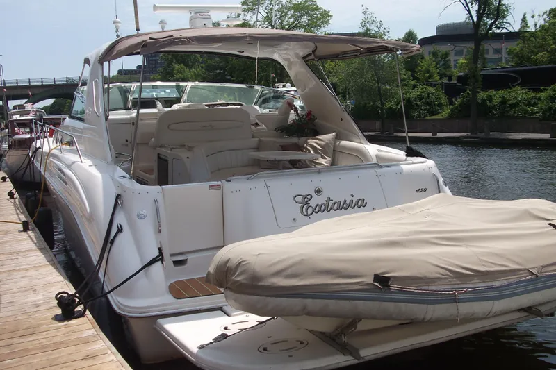  Yacht Photos Pics 1997 Sea Ray 450 Sundancer yacht docked, featuring spacious deck and elegant design.