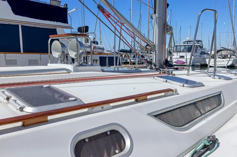 Crazy Horse Yacht Photos Pics 2001 Jeanneau Sun Odyssey 52.2 sailboat deck in marina, showcasing sleek design and rigging.