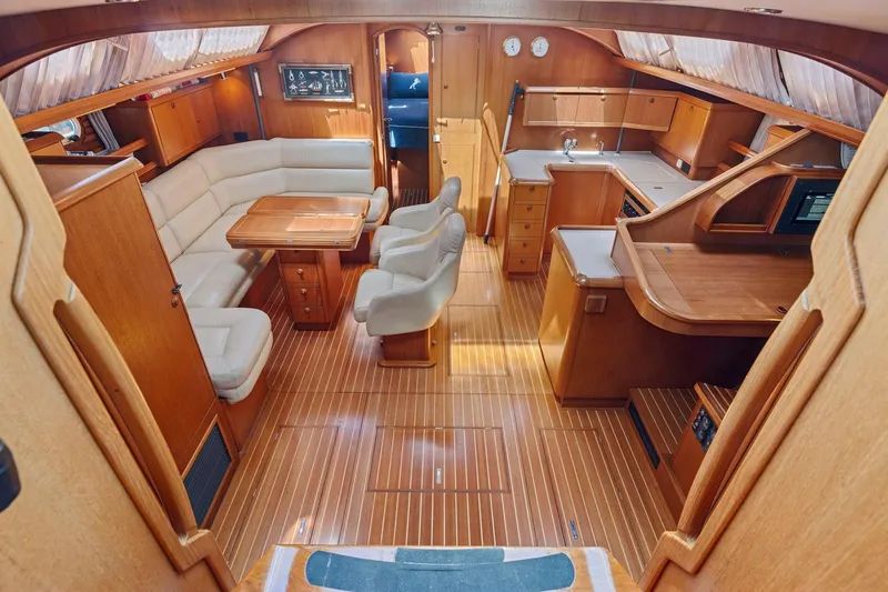 Crazy Horse Yacht Photos Pics Luxurious interior of 2001 Jeanneau Sun Odyssey 52.2 yacht with wood finish and seating area.