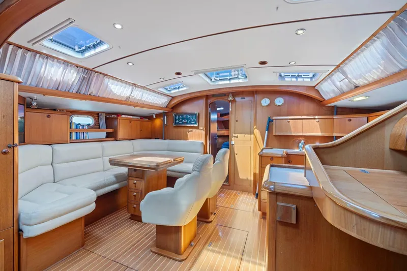 Crazy Horse Yacht Photos Pics Luxurious interior of 2001 Jeanneau Sun Odyssey 52.2 yacht with elegant wood finish.