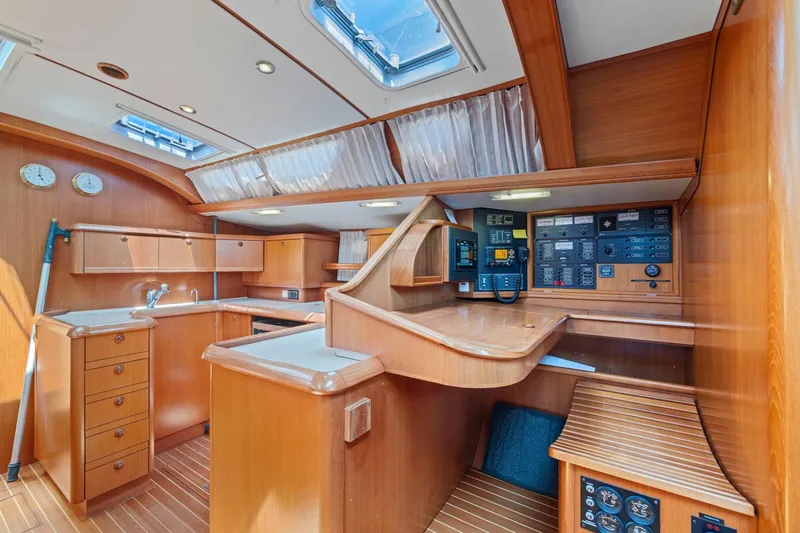 Crazy Horse Yacht Photos Pics Luxurious 2001 Jeanneau Sun Odyssey 52.2 yacht interior with wood finish and navigation controls.