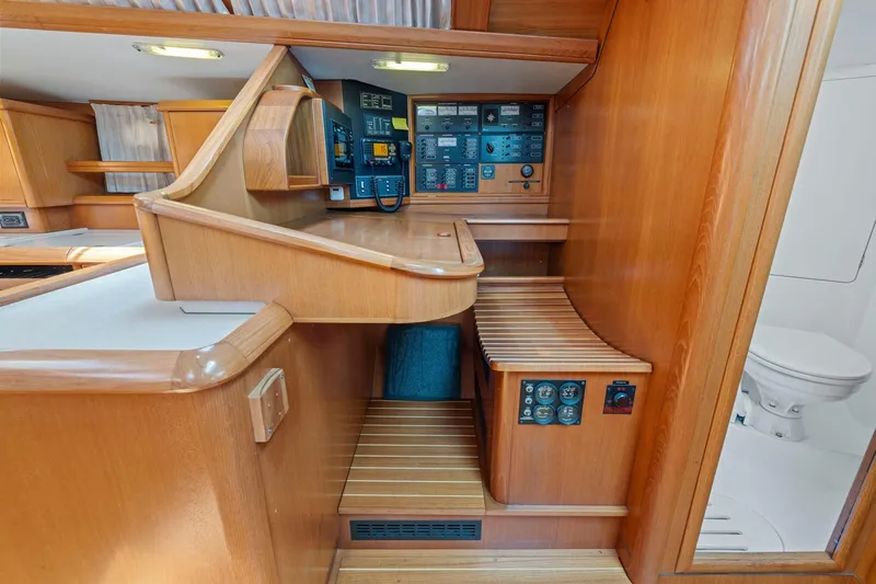 Crazy Horse Yacht Photos Pics Interior of 2001 Jeanneau Sun Odyssey 52.2 yacht with navigation panel and wooden finish.
