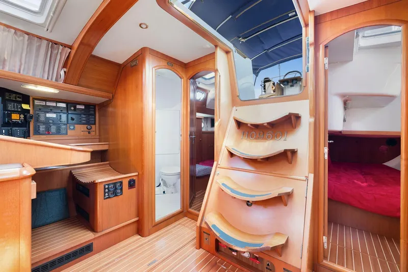 Crazy Horse Yacht Photos Pics Interior of 2001 Jeanneau Sun Odyssey 52.2 sailboat, featuring wood paneling and cozy cabin spaces.