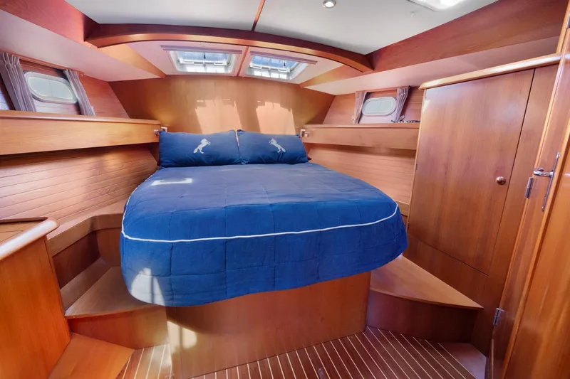 Crazy Horse Yacht Photos Pics Luxurious cabin interior of 2001 Jeanneau Sun Odyssey 52.2 sailboat with wooden finish.