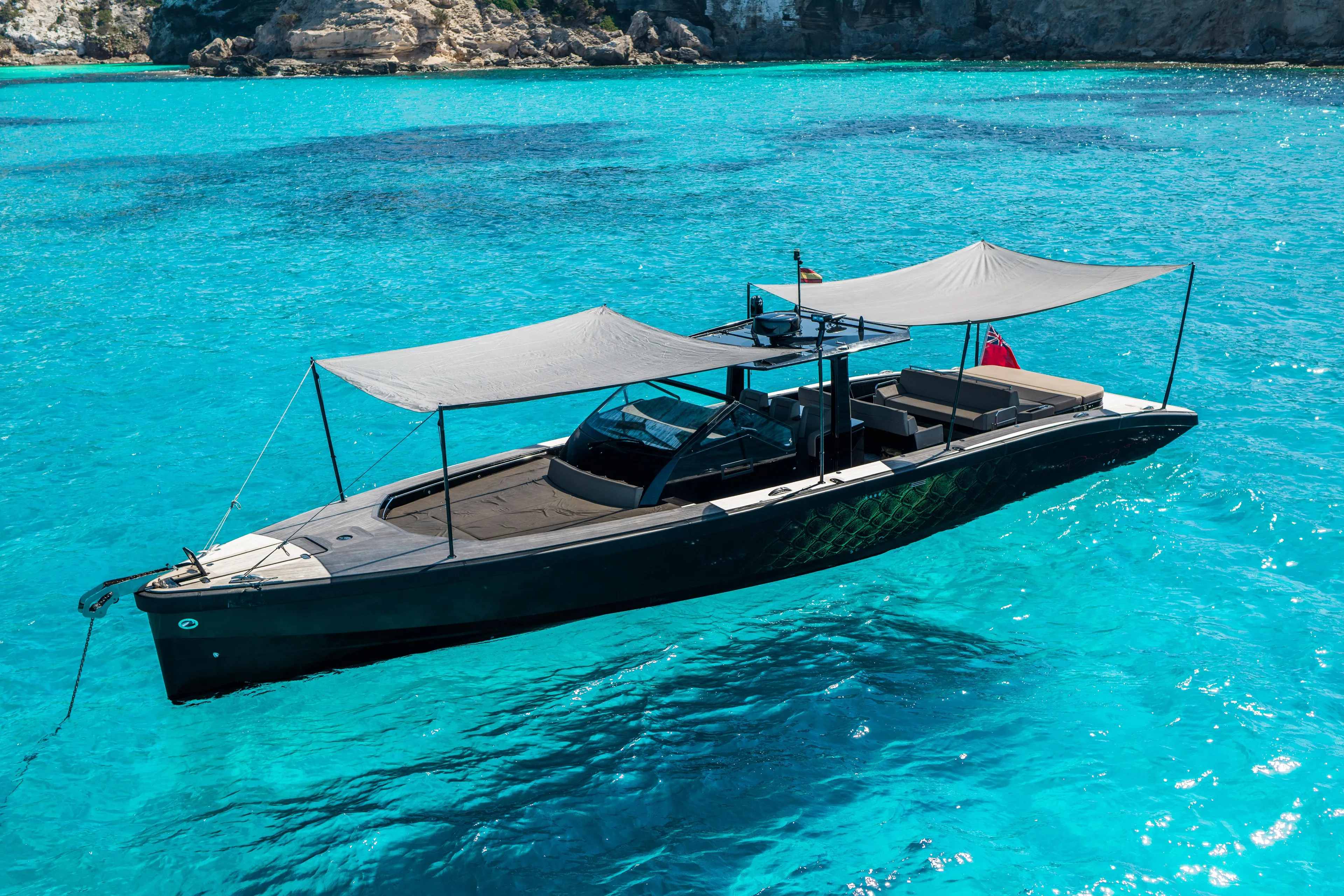 Dragon Yacht Photos Pics 2017 Windy SR52 Blackbird yacht on clear turquoise water, featuring sleek design and sunshades.