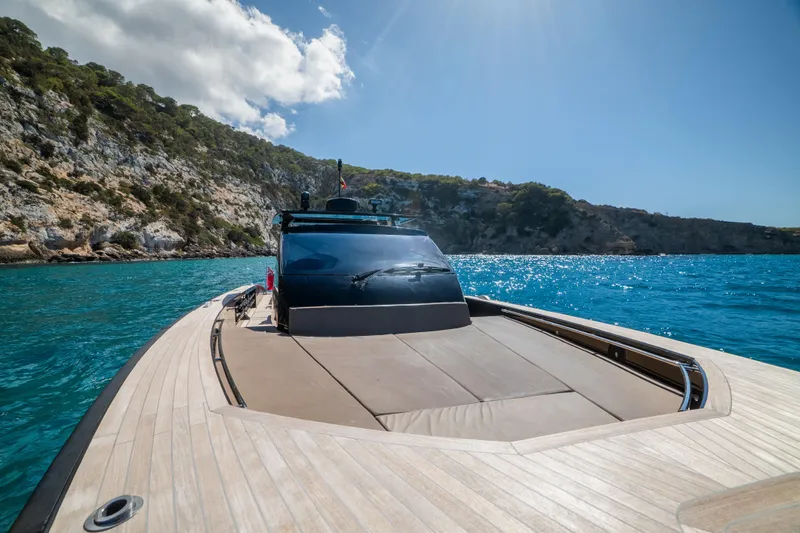 Dragon Yacht Photos Pics 2017 Windy SR52 Blackbird yacht cruising in clear blue waters near rocky coastline.
