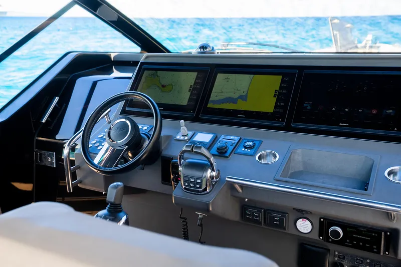 Dragon Yacht Photos Pics Cockpit of 2017 Windy SR52 Blackbird yacht with navigation screens and steering wheel.