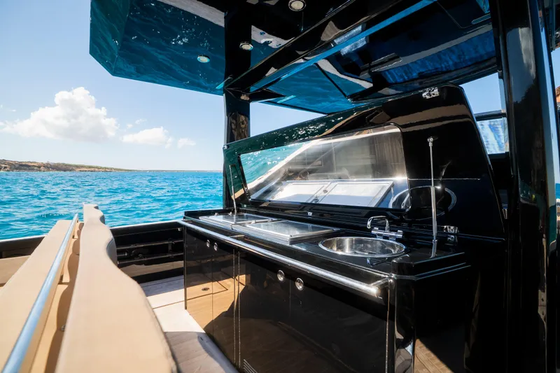 Dragon Yacht Photos Pics Luxurious 2017 Windy SR52 Blackbird yacht with sleek black kitchen and ocean view.