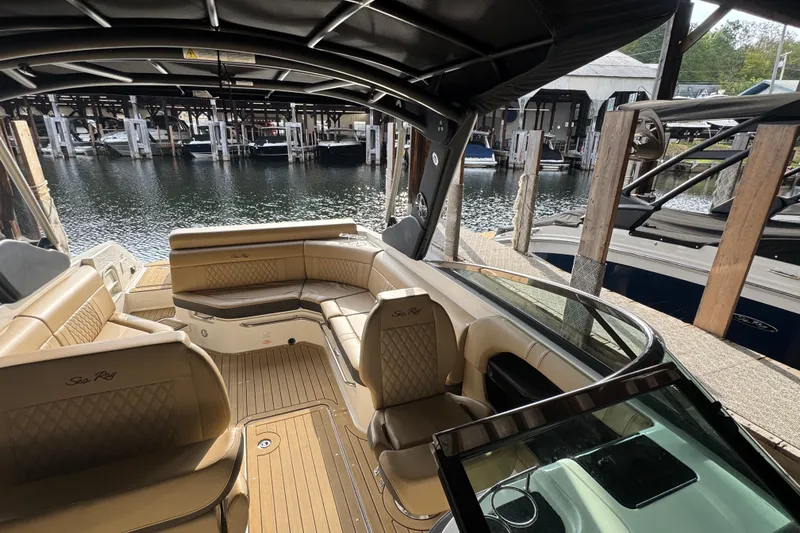  Yacht Photos Pics 2021 Sea Ray SLX 280 boat interior with tan seating, docked at marina.