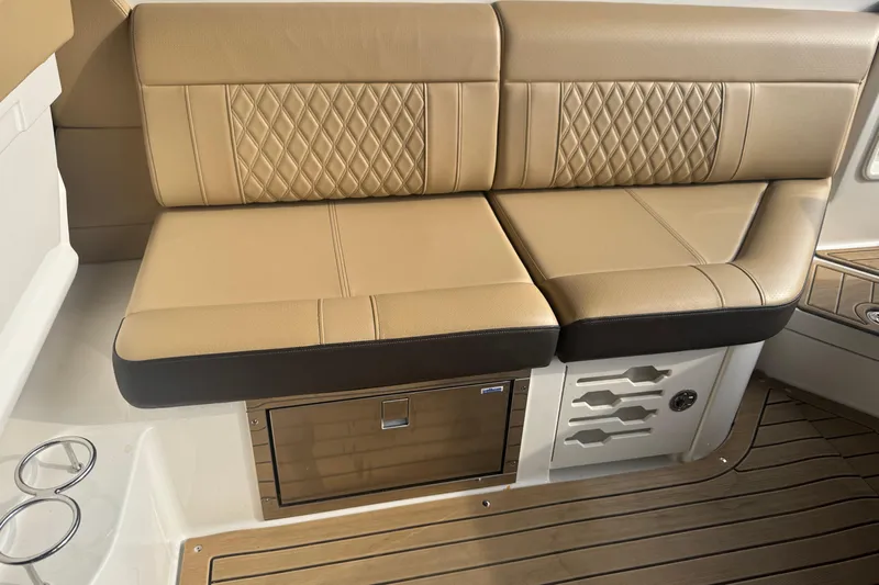  Yacht Photos Pics Luxurious tan seating on 2021 Sea Ray SLX 280 boat with wood flooring.