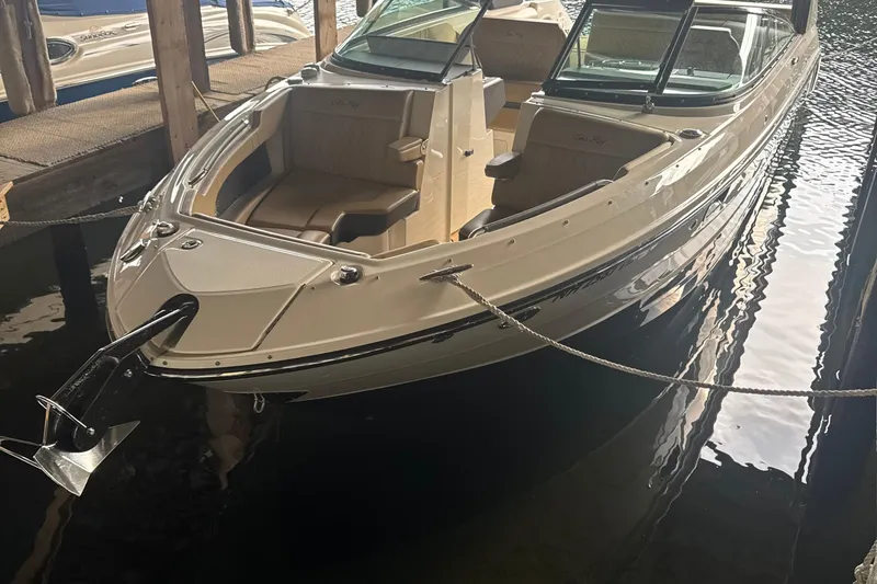  Yacht Photos Pics 2021 Sea Ray SLX 280 boat docked in a marina, showcasing sleek design and spacious seating.