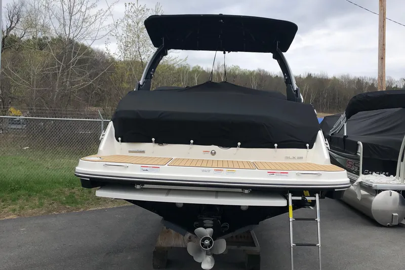  Yacht Photos Pics 2021 Sea Ray SLX 280 boat with black cover, parked outdoors.