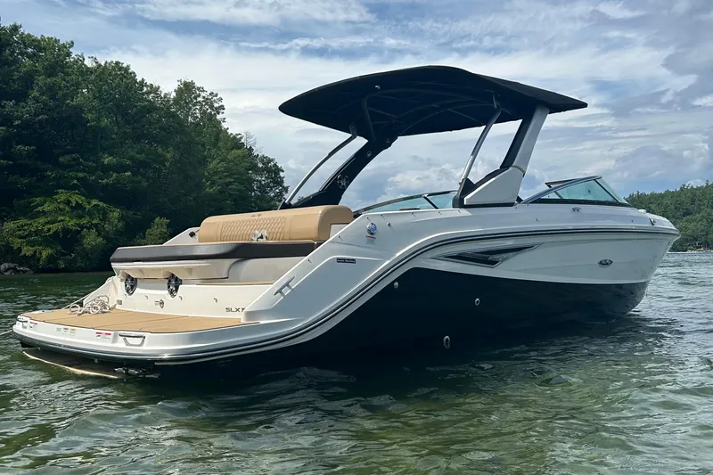  Yacht Photos Pics 2021 Sea Ray SLX 280 boat on a serene lake with lush greenery.