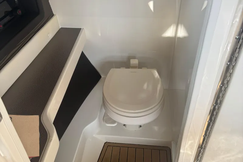  Yacht Photos Pics 2021 Sea Ray SLX 280 boat interior with compact marine toilet.
