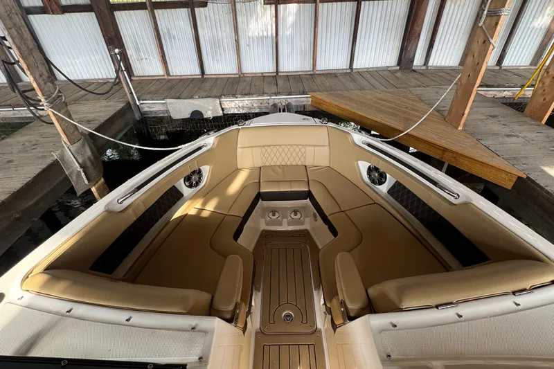  Yacht Photos Pics 2021 Sea Ray SLX 280 boat interior with tan seating, docked in a covered marina.