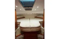 Interior cabin of 2022 Nimbus 405 Coupé with cozy bed and skylight.
