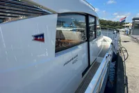 2022 Nimbus 405 Coupé yacht docked at a marina under a clear blue sky.