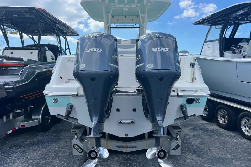  Yacht Photos Pics 2020 Robalo R302 Center Console with dual Yamaha 300 engines, docked under blue sky.