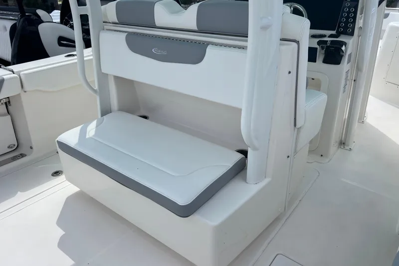  Yacht Photos Pics 2020 Robalo R302 Center Console boat interior with white seating and control panel.