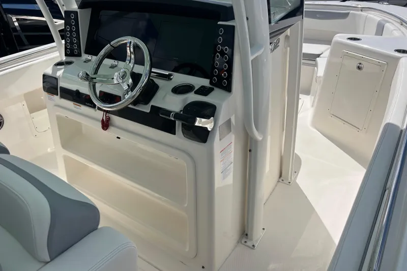  Yacht Photos Pics 2020 Robalo R302 Center Console boat interior with steering wheel and control panel.