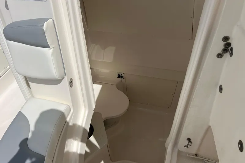  Yacht Photos Pics 2020 Robalo R302 Center Console boat interior with seating and toilet.