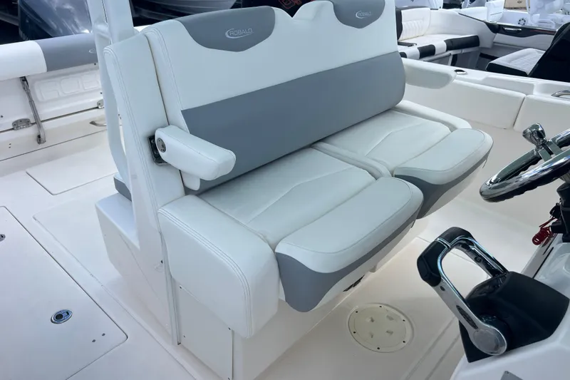  Yacht Photos Pics 2020 Robalo R302 Center Console boat with dual cushioned seats and steering wheel.
